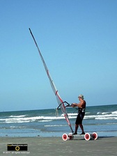 Cool picture of a beachside wind surfer on wheels.© 2011, FreePhotoCourse.com, all rights reserved.  Awesome beach pictures & wallpapers. Download free jpg, jpeg photos.  