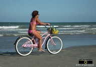 Downloadable picture of a girl wearing a pink bikini, riding her matching pink bicycle on the beach.© 2011, FreePhotoCourse.com, all rights reserved.  Awesome beach pictures & wallpapers. Download free jpg, jpeg photos.  