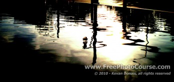 Wavy Reflection in Puddle at Side of Road - Fine Art Photography Tips and Lessons - © 2010, Kevan Donais.  Visit www.FreePhotoCourse.com, all rights reserved 
