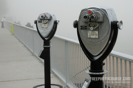 Picture of a pair of coin-operated binoculars on a waterfront vista. Used to illustrate the Rule of Thirds in photographic composition. Part of a tutorial by FreePhotoCourse.com; © 2012, all rights reserved.