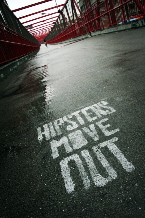 Picture of the Williamsburg Bridge, New York City, grafitti on pavement 'Hipsters Move Out'; part of the popular New York City Photography Exhibit 'NYC Exposed' by FreePhotoCourse.com; photo credit: Stan Baranski, all rights reserved