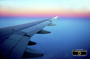 Aircraft Pictures.  Depicts wing of a commercial airline jet over city at cruising altitude.© 2011, FreePhotoCourse.com, all rights reserved.  Free high-res desktop wallpapers and pictures.   