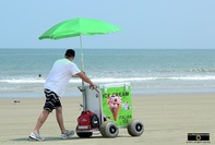 Picture of a man pushing his ice-cream cart on a beach. © 2011, FreePhotoCourse.com, all rights reserved.  Awesome beach pictures & wallpapers. Download free jpg, jpeg photos. 