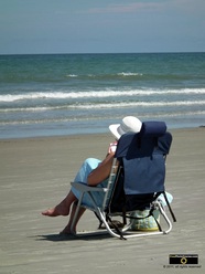 Serene picture of a woman relaxing in a folding chair at the sea shore.© 2011, FreePhotoCourse.com, all rights reserved.  Awesome beach pictures & wallpapers. Download free jpg, jpeg photos.  