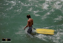 Cool picture of a boy towing his yellow boogie-board into the waves at the beach. © 2011, FreePhotoCourse.com, all rights reserved.  Awesome beach pictures & wallpapers. Download free jpg, jpeg photos. 