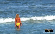 Picture of an attractive young woman wearing yellow string bikini, wading into the ocean. © 2011, FreePhotoCourse.com, all rights reserved.  Awesome beach pictures & wallpapers. Download free jpg, jpeg photos. 