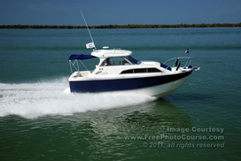 Picture of a power boat on still green-blue water.  Find more great free pictures and wallpapers at www.FreePhotoCourse.com.© 2011, FreePhotoCourse.com; all rights reserved.  