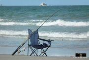 Picture of a folding chair and fishing rod - classic beach scene. © 2011, FreePhotoCourse.com, all rights reserved.  Awesome beach pictures & wallpapers. Download free jpg, jpeg photos. 