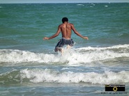 Picture of a boy jumping over waves near the sea shore. © 2011, FreePhotoCourse.com, all rights reserved.  Awesome beach pictures & wallpapers. Download free jpg, jpeg photos. 