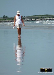 Artistic photograph of a woman and her reflection at the ocean water's edge. © 2011, FreePhotoCourse.com, all rights reserved.  Awesome beach pictures & wallpapers. Download free jpg, jpeg photos.  