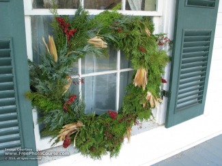 Picture of a Christmas wreath on a window with shutters; enjoy more free pictures and wallpapers from www.FreePhotoCourse.com; ©2010, all rights reserved 