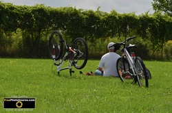 Picture of two cyclists taking a break and resting on a lawn.© 2011, FreePhotoCourse.com, all rights reserved.  Free high-res desktop wallpapers and pictures.  