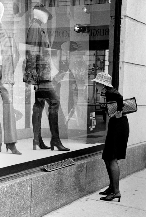 Picture of a well-dressed woman looking into the window display at Bergdorg-Goodman in New York City; photo credit: Joseph Consantino; part of the 'NYC Exposed' photography exhibit at FreePhotoCourse.com; all rights reserved 