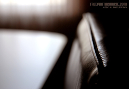 Beautiful abstract photo of a leather chair and table.  Part of a photo composition tutorial by FreePhotoCourse.com; © 2012, all rights reserved.