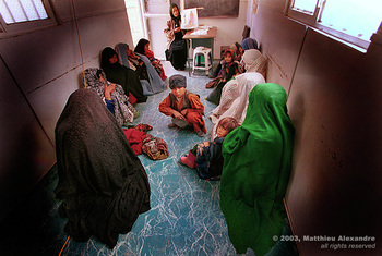 Picture of women in an Afghanistan camp attending a women's contraception workshop put on by Medicins Du Monde.  © 2003, Matthieu Alexandre; part of FreePhotoCourse.com's “Photographer Profiles” series; DO NOT COPY – IP Address recorded - all rights reserved.