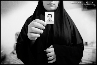 Picture of a Sunni Iraqi refugee in Lebanon, holding a picture of her missing husband.  © 2009, Matthieu Alexandre; part of FreePhotoCourse.com's “Photographer Profiles” series; DO NOT COPY – IP Address recorded - all rights reserved.