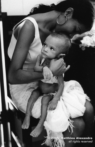 Picture of a woman holding her malnourished son, waiting for help from a food program in Fortaleza, Brazil.  © 2001, Matthieu Alexandre; part of FreePhotoCourse.com's “Photographer Profiles” series; DO NOT COPY – IP Address recorded - all rights reserved.